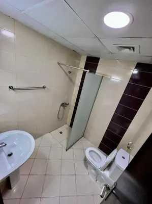 a bathroom with a toilet and a sink at Small Private Partition Room in Al Barsha 1 Near Metro in Dubai