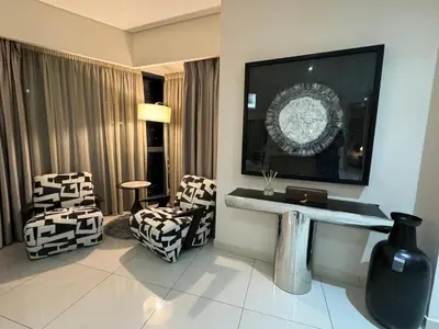 a hotel room with two chairs and a sink at ROYAL APARTMENTS By Damac Paramount Towers B Burj Khalifa Views in Dubai