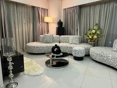 a living room with two couches and a table at ROYAL APARTMENTS By Damac Paramount Towers B Burj Khalifa Views in Dubai