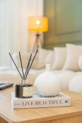 a living room with a table with a vase on it at Azure Escape !Joyful 1 Bed Apartment close to the Sea! in Dubai