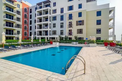 a swimming pool in front of some apartment buildings at Azure Escape !Joyful 1 Bed Apartment close to the Sea! in Dubai