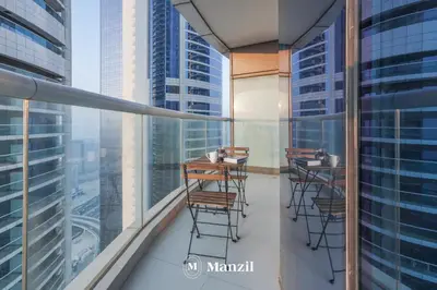 a balcony with chairs and tables on a building at Manzil - Stunning 3BR Apt in Paramount nr Burj in Dubai