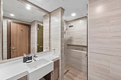 a bathroom with a sink and a shower at StoneTree - Modern 1BR with Amazing Building Facilities in Dubai