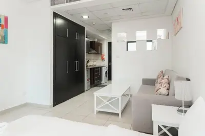 a living room with a couch and a table at StoneTree - Fully Furnished Studio with Spacious Balcony in Dubai