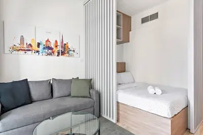 a living room with a couch and a table at Cozy Studio By Burj Khalifa and Dubai Mall in Dubai