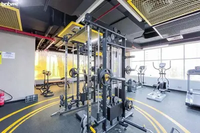 a gym with several rows of exercise equipment in a room at Cozy Studio By Burj Khalifa and Dubai Mall in Dubai