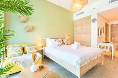 a bedroom with a large bed and a couch at Stunning Apt with Balcony & Marina View in Dubai