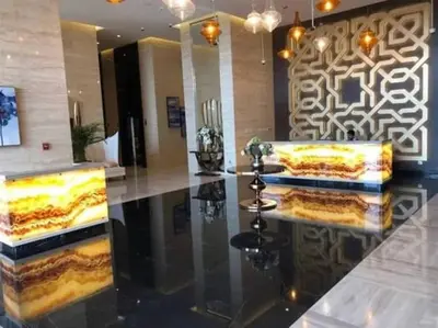 a lobby with two cakes on a counter in a building at Ghalia Damac Studio Apartment in Dubai