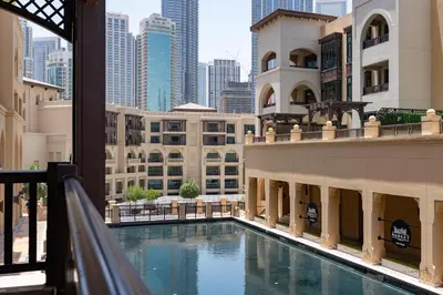 a view of a building with a swimming pool at Lux BnB I Souk Al Bahar I Burj Khalifa Views in Dubai