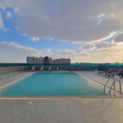 a swimming pool on the roof of a building at Stylish Studio For Two in Dubai