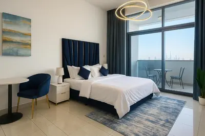 a bedroom with a bed and a table and chairs at Stylish Studio For Two in Dubai