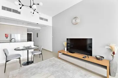 a living room with a large flat screen tv at StoneTree - Best Deal - Elegant Studio in Dubai