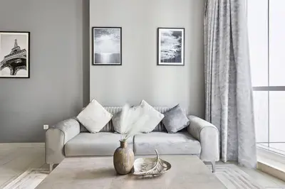 a living room with a couch and a table at StoneTree - Elegant 1BR in Famous Location in Dubai