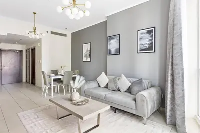 a living room with a couch and a table at StoneTree - Elegant 1BR in Famous Location in Dubai