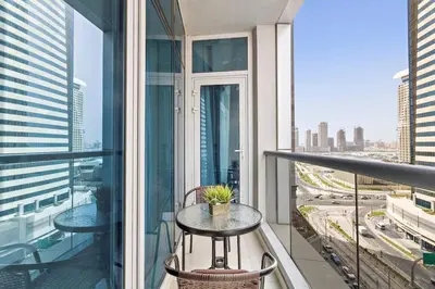 a balcony with a table and chairs on a building at StoneTree - Elegant 1BR in Famous Location in Dubai