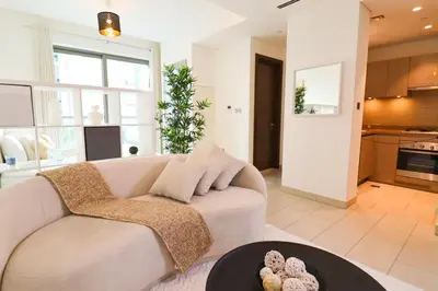 a living room with a couch and a table at Celestial Ambiance Studio in Dubai
