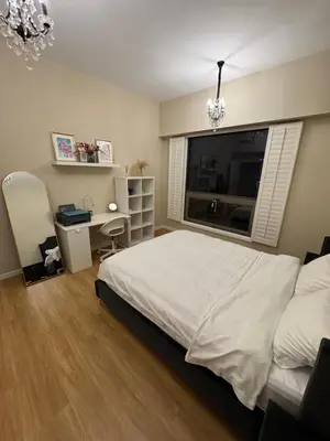 a bedroom with a bed and a desk and a window at Upscale 3br in JBR next to Ritz-Carlton in Dubai