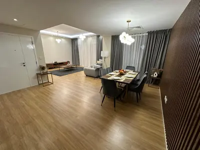a living room with a table and chairs and a couch at Upscale 3br in JBR next to Ritz-Carlton in Dubai