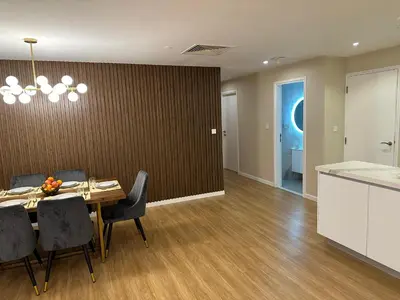 a dining room with a table and chairs and a kitchen at Upscale 3br in JBR next to Ritz-Carlton in Dubai