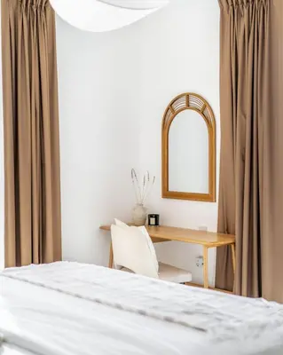 a bedroom with a bed and a desk with a mirror at GuestReady - Exquisite stay near Dubai Canal in Dubai