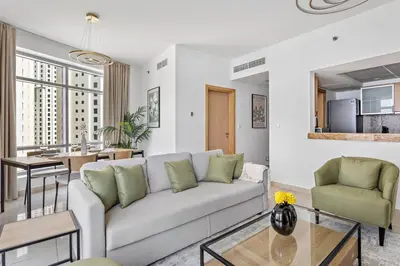a living room with a couch and a table at StoneTree - Stylish fully-furnished 1 BR in Dubai