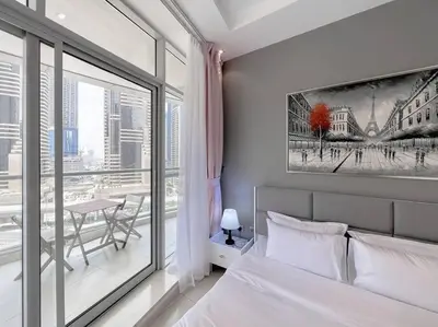 a bedroom with a bed and a large window at StoneTree - Amazing View - Modern 1BR in Dubai
