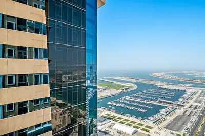 an aerial view of a building and a harbor at StoneTree - High Floor Furnished 1 BR in Dubai