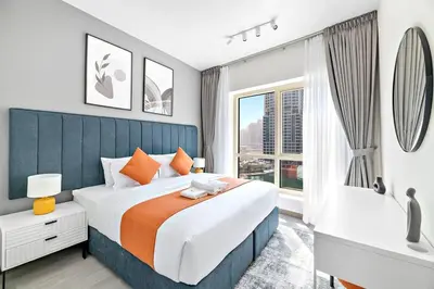 a bedroom with a large bed and a window at StoneTree - Furnished 1BR with Stunning View in Dubai