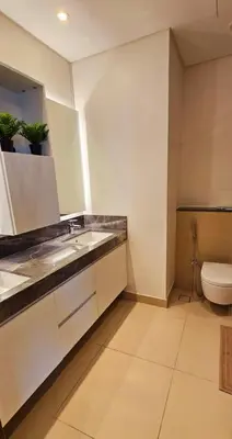 a bathroom with a sink and a toilet at Amazing 4-bedroom Apartment in Dubai
