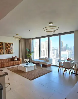 a living room with a couch and a table at Amazing 4-bedroom Apartment in Dubai