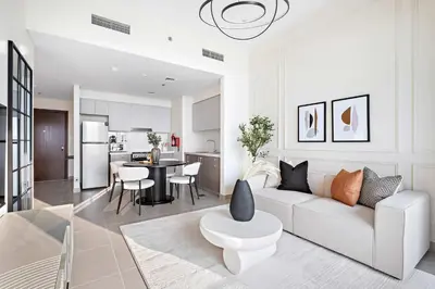 a living room with a white couch and a table at Silkhaus classical 1BDR in Opera District in Dubai