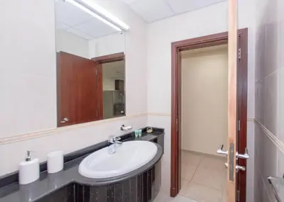 a bathroom with a sink and a mirror at StoneTree - Near Tram - Furnished 1BR in Dubai