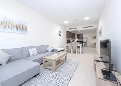 a living room with a couch and a table at StoneTree - Near Tram - Furnished 1BR in Dubai