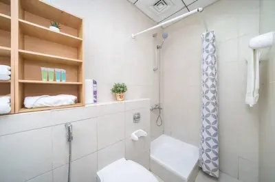 a bathroom with a shower and a toilet in it at StoneTree - Lake View - Family-Friendly Location in Dubai