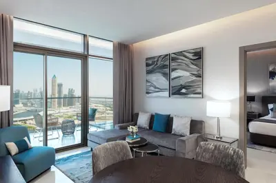 a living room with a couch and a bed at DAMAC Maison Aykon City Dubai in Dubai