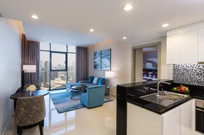 a kitchen and living room with a view of the city at DAMAC Maison Aykon City Dubai in Dubai