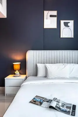 a bedroom with a bed with a magazine on it at Cozy Heaven with full Marina View in Dubai