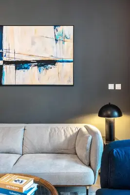 a living room with a couch and a painting on the wall at Cozy Heaven with full Marina View in Dubai