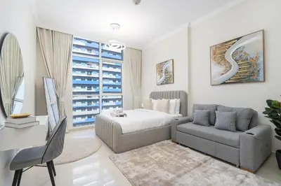 a bedroom with a bed and a couch and a chair at Heaven Crest Vacation Homes Downtown - Studio and 1 Bedroom Suites 2 minute walk to Dubai Mall and Burj Khalifa in Dubai