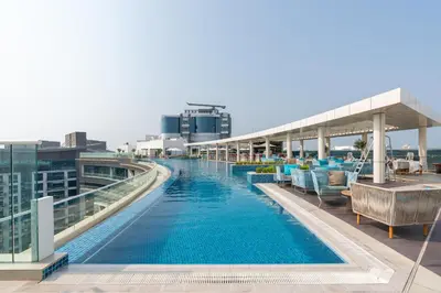 a swimming pool on the roof of a building at Dream Inn - Seven Palm - Free Beach Access in Dubai