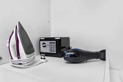 a phone and a hair dryer sitting on a counter at StoneTree - Near Beach - Furnished 1BR with Partial Sea View in Dubai