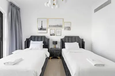 two beds sitting next to each other in a bedroom at StoneTree - 2 BR apartment in Golden Mile 6 Near Nakheel Mall in Dubai