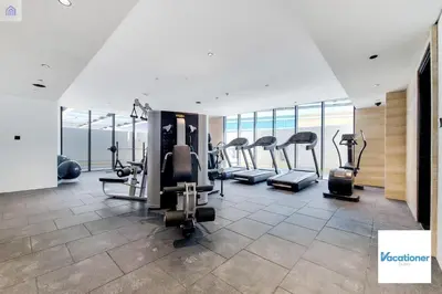 a gym with treadmills and ellipticals in a building at O Ten, Al Jaddaf - Neat Studio in Dubai