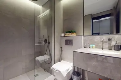 a bathroom with a shower and a toilet and a sink at O Ten, Al Jaddaf - Neat Studio in Dubai