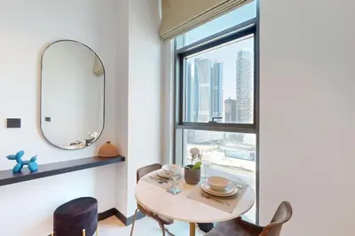 a dining room with a table and a mirror at 15 Northside Tower 1 - Elegant Studio in Dubai