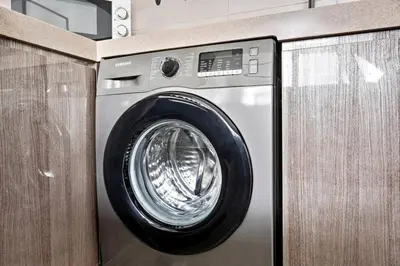 a washing machine in a room with a counter at StoneTree - New stylish 1 BR Apartment in JLT in Dubai