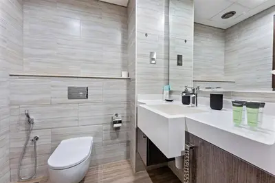 a bathroom with a white toilet and a sink at StoneTree - New stylish 1 BR Apartment in JLT in Dubai