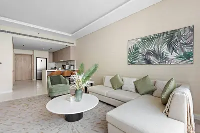 a living room with a couch and a table at StoneTree - Spacious 1 BR with Stunning Sea View in Palm Jumeirah in Dubai