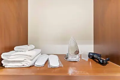 a bathroom counter with towels and a hair dryer on it at StoneTree - Luxurious 2 BR Apartment in Palm Jumeirah in Dubai