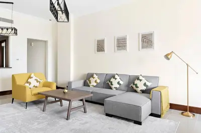 a living room with a couch and two chairs at StoneTree - Luxurious 2 BR Apartment in Palm Jumeirah in Dubai
